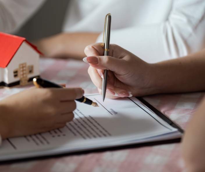 Signing a purchase and sale agreement after ensuring HVAC system is efficient.